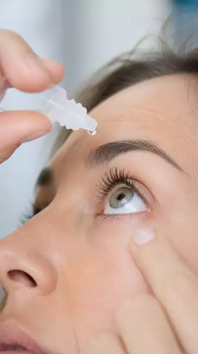 Person using eye drops for dry eyes, close up