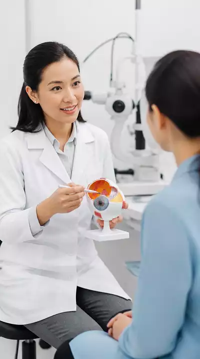 Optometrist explaining eye conditions to a patient